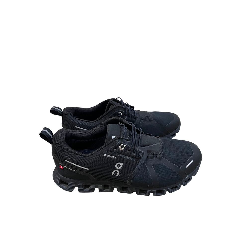 On Cloud waterproof running shoes for women in solid black. - Picture 3 of 9